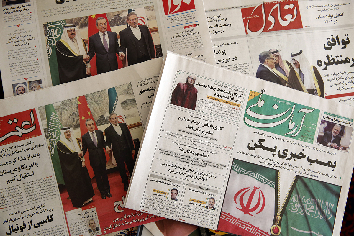 Photo above: Newspapers in Tehran feature on their front page news about the China-brokered deal between Iran and Saudi Arabia to restore ties, signed in Beijing the previous day, on March, 11 2023. Photo by ATTA KENARE/AFP via Getty Images.